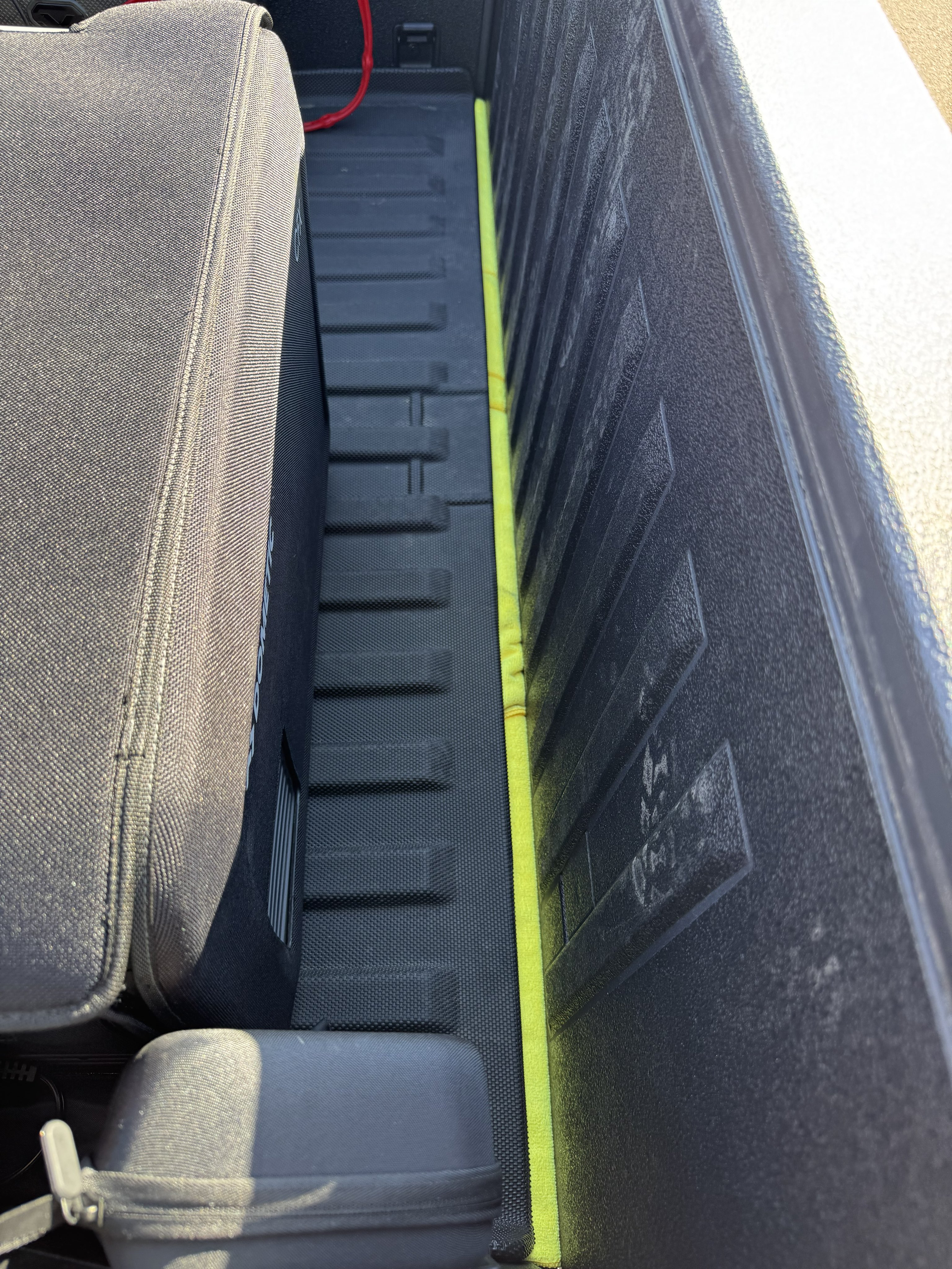 Close-up of microfiber towel sealing technique under Cybertruck bed mat
